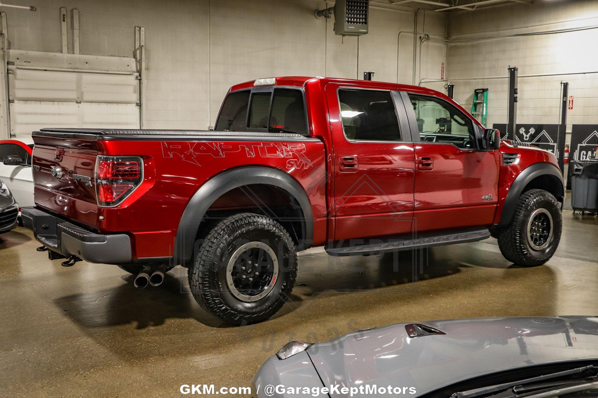 Red Ford Raptor Lifted